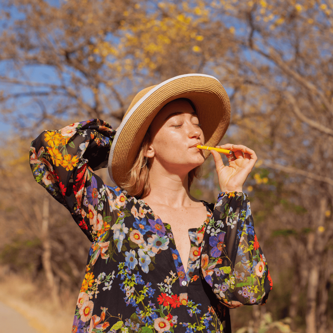 woman in colorful dress holding MONQ Aromatherapy diffuser