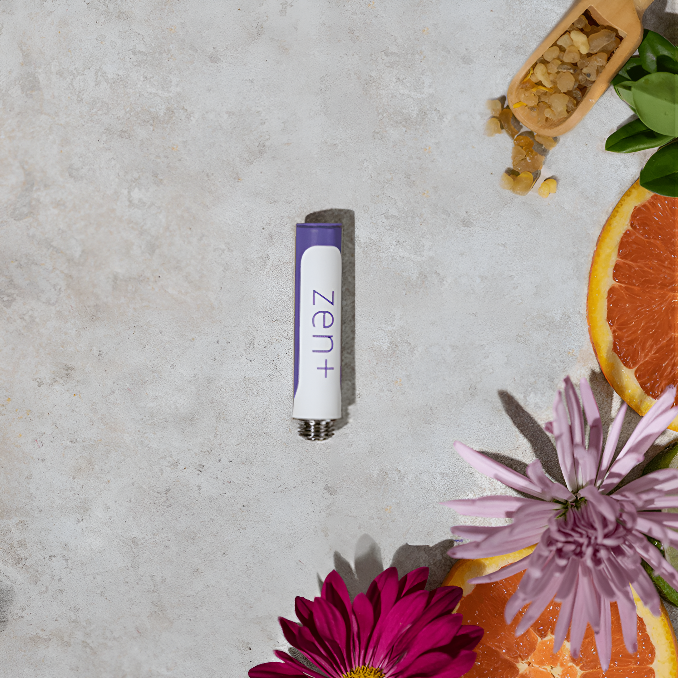  A flatlay shot of the Zen MONQ CBD blend against a beige background beside flowers and fruit.